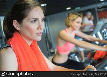 portrait of women exercising on machines