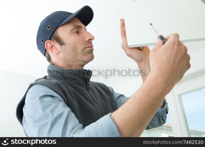 portrait of worker assembling a furniture