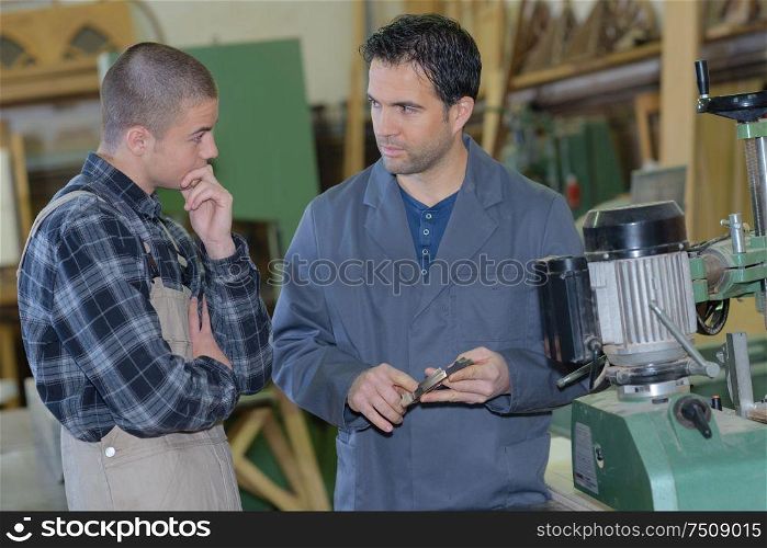 portrait of worker teaching an apprentice
