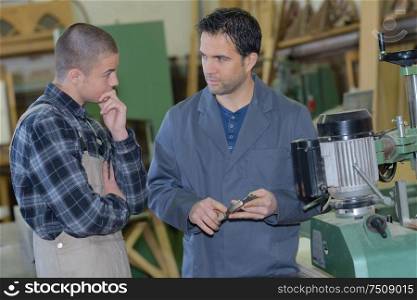 portrait of worker teaching an apprentice