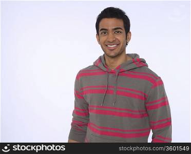 Portrait of young (20-25 years) man, smiling, studio shot