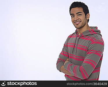 Portrait of young (20-25 years) man, smiling, studio shot