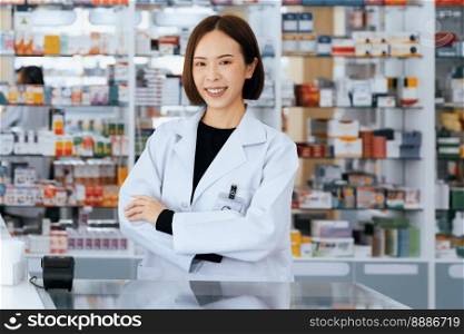 Portrait of young affable pharmacist and qualified pharmaceutical, medicine pill container or bottle mockup for copyspace at pharmacy. Druggist working with her diary job at drugstore, medicine shelf.. Portrait of young asian pharmacist pill bottle mockup at qualified pharmacy