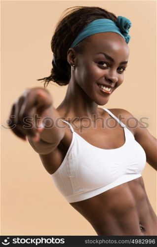 Portrait of young african athletic girl pointing at camera
