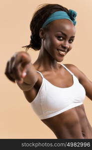 Portrait of young african athletic girl pointing at camera