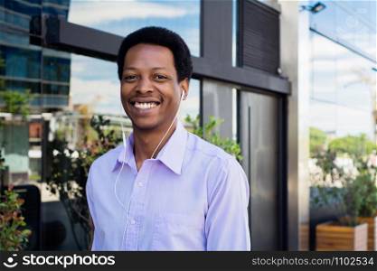 Portrait of young Afro American businessman in the city.