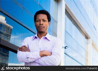 Portrait of young Afro American businessman in the city.