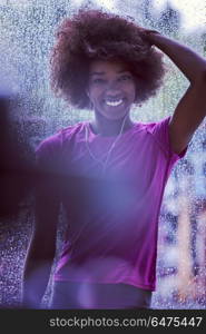 portrait of young afro american woman in gym on work out break while teaking breath and fresh water rainy day and bad weather outdooor. portrait of young afro american woman in gym