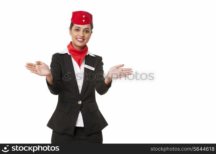 Portrait of young air hostess gesturing over white background