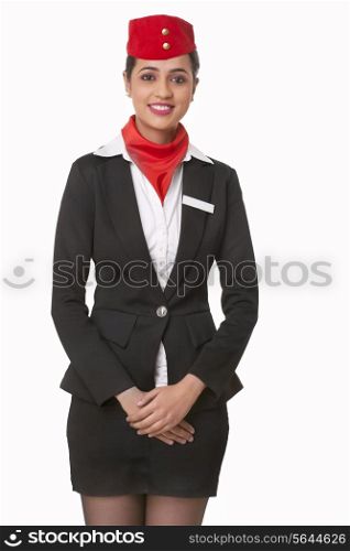 Portrait of young airhostess standing over white background
