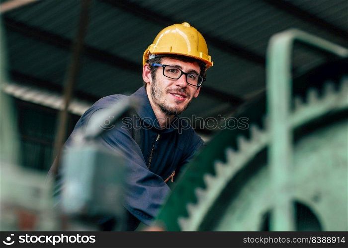 Portrait of young American happy worker enjoy happy smiling to work in a heavy industrial factory.