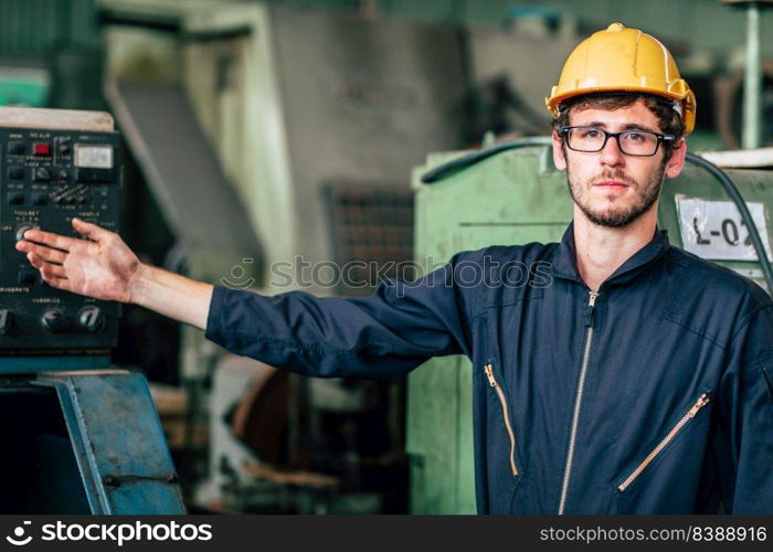 Portrait of young American happy worker enjoy happy smiling to work in a heavy industrial factory.hand present posture.