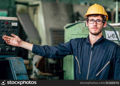 Portrait of young American happy worker enjoy happy smiling to work in a heavy industrial factory.hand present posture.