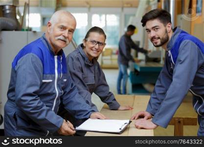 portrait of young apprentices in carpentry school