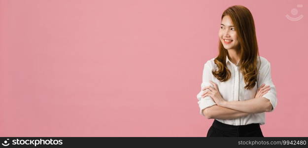 Portrait of young Asia lady with positive expression, arms crossed, smile broadly, dressed in casual clothing and looking at space over pink background. Panoramic banner background with copy space.