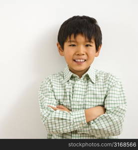 Portrait of young Asian boy smiling.