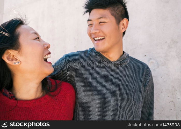 Portrait of young Asian couple in love hugging and having good time together. Love concept.