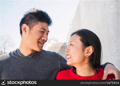 Portrait of young Asian couple in love hugging and having good time together. Love concept.