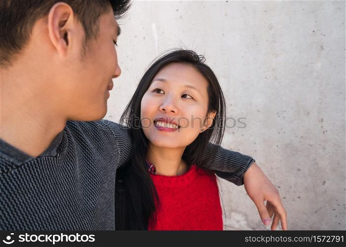 Portrait of young Asian couple in love hugging and having good time together. Love concept.