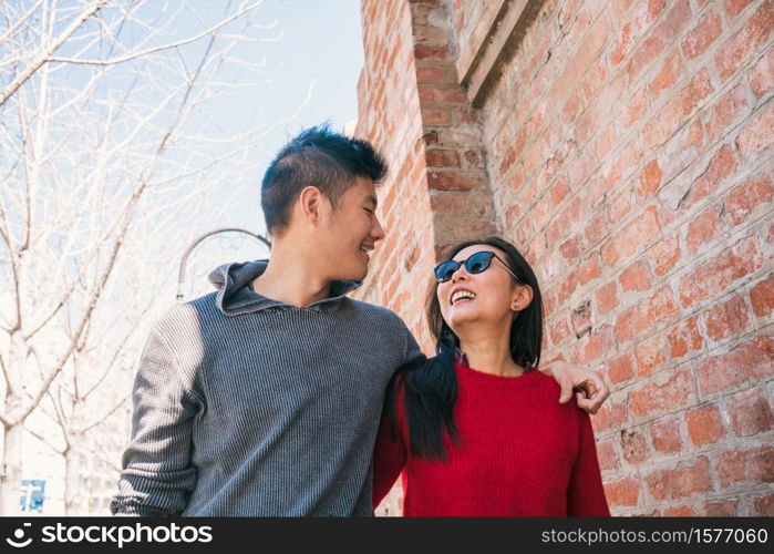 Portrait of young Asian couple in love walking in the city and having good time together. Love concept.