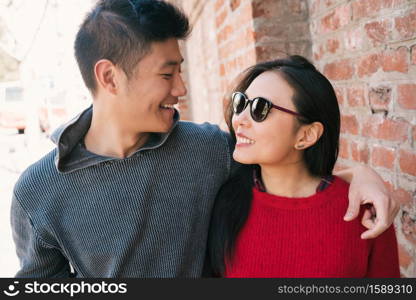 Portrait of young Asian couple in love walking in the city and having good time together. Love concept.