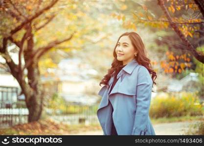 Portrait of young asian girl in autumn park