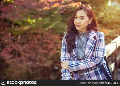 Portrait of young asian girl in autumn park