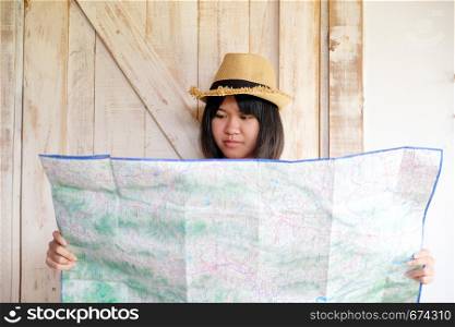 Portrait of young asian girl traveler holding map with smiling face, travel summer holiday vacation concept