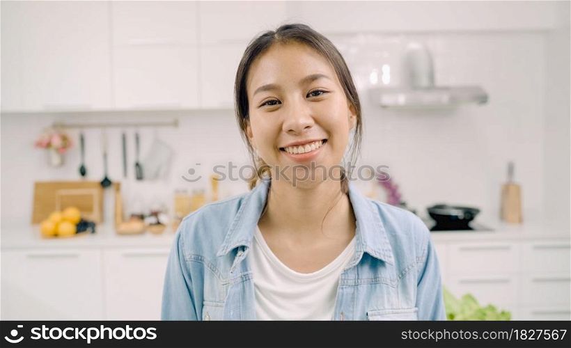 Portrait of young Asian Latin woman feeling happy smiling at home. Hispanic girl relax toothy smile looking to camera in kitchen at home in the morning concept.