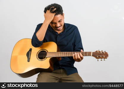 Portrait of Young Asian man playing an acoustic guitar isolated on white background. Music, entertainment and hobby concept.
