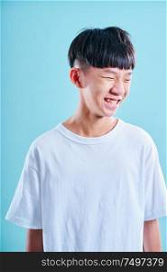 Portrait of Young asian teenage boy laugh .