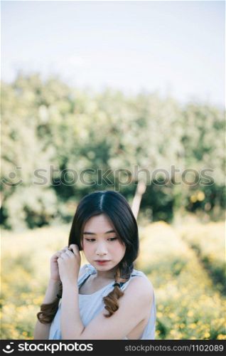 Portrait of Young Asian woman girl smile in flower garden
