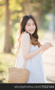 Portrait of Young Asian woman girl smile in flower garden