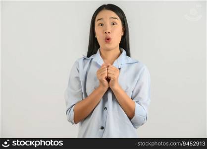 Portrait of Young asian woman in blue shirt looking at camera and exciting isolated on white background. Expression and lifestyle concept.