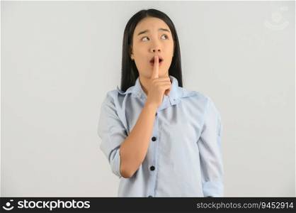 Portrait of Young asian woman in blue shirt thinking and looking up isolated on white background. Expression and lifestyle concept.