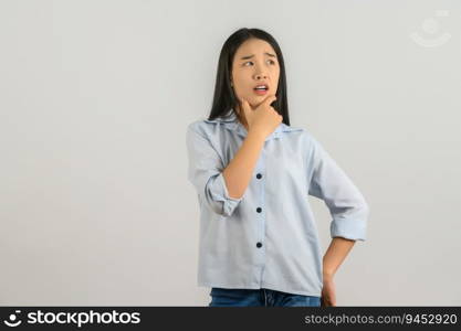 Portrait of Young asian woman in blue shirt thinking and looking up isolated on white background. Expression and lifestyle concept.