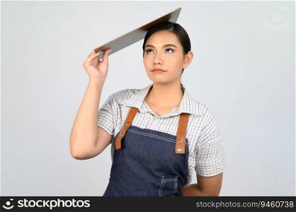 Portrait of young asian woman in waitress uniform holding clipboard on over head, copy space to insert products for advertisement isolated on white background