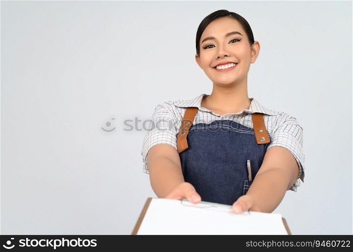 Portrait of young asian woman in waitress uniform holding mock up clipboard with pen, copy space to insert text for advertisement isolated on white background