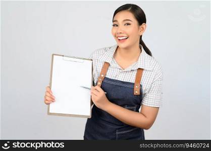 Portrait of young asian woman in waitress uniform holding mock up clipboard with pen, copy space to insert text for advertisement isolated on white background