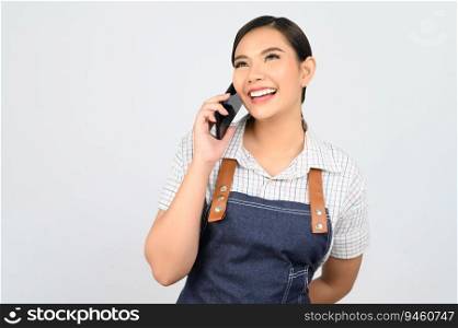 Portrait of young asian woman in waitress uniform use smartphone to talking during work, copy space for insert products for advertisement isolated on white background