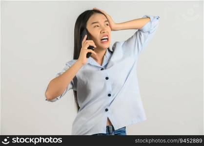 Portrait of Young asian woman talking on mobile phone while standing isolated over white background. Technology concept.