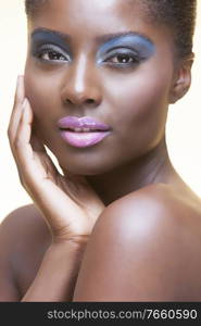 Portrait of young attractive african american woman with full make up on in studio