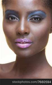 Portrait of young attractive african american woman with full make up on in studio