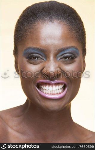 Portrait of young attractive african american woman with full make up on in studio