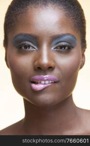 Portrait of young attractive african american woman with full make up on in studio