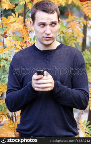 Portrait of young attractive man calling by phone