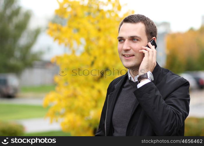 Portrait of young attractive man calling by phone