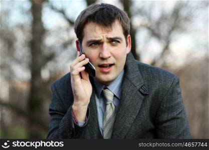 Portrait of young attractive man calling by phone
