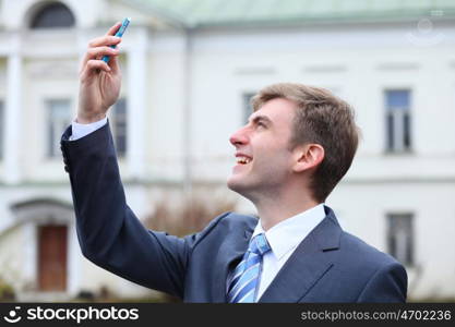 Portrait of young attractive man calling by phone