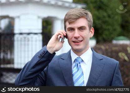 Portrait of young attractive man calling by phone